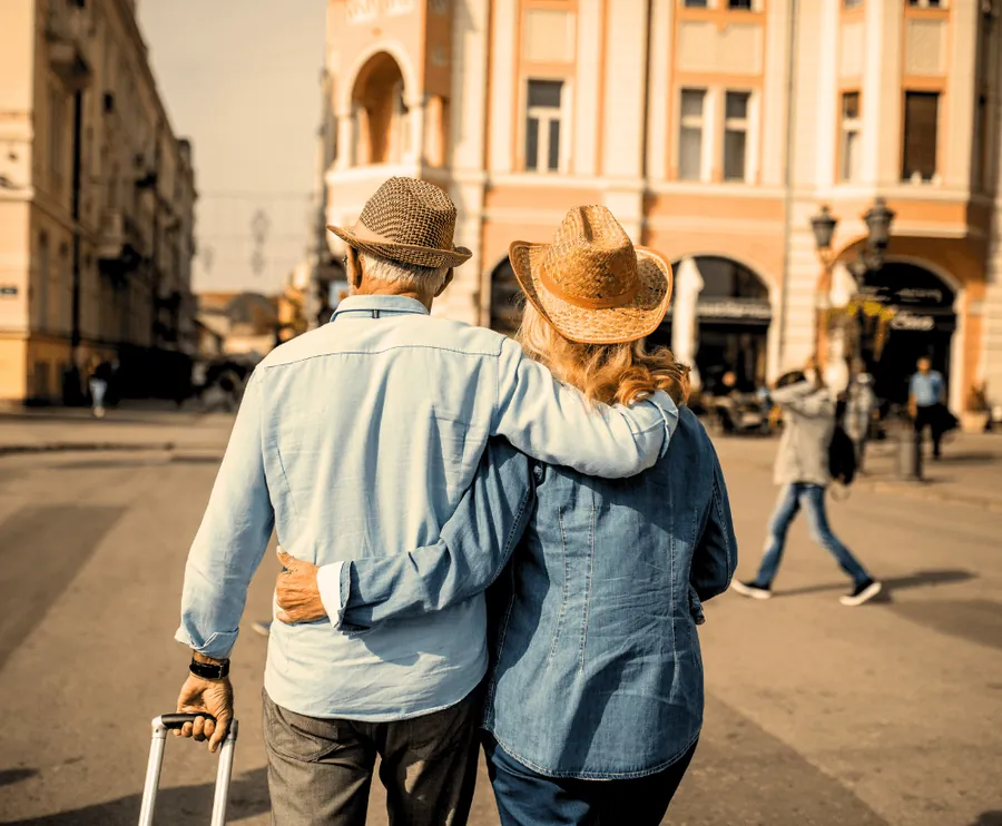 Casal caminhando abraçado em cidade histórica